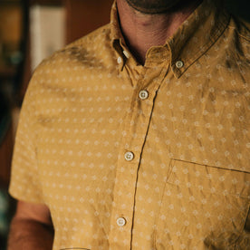 fit model showing the pattern and buttons on The Short Sleeve Jack in Gold Diamond