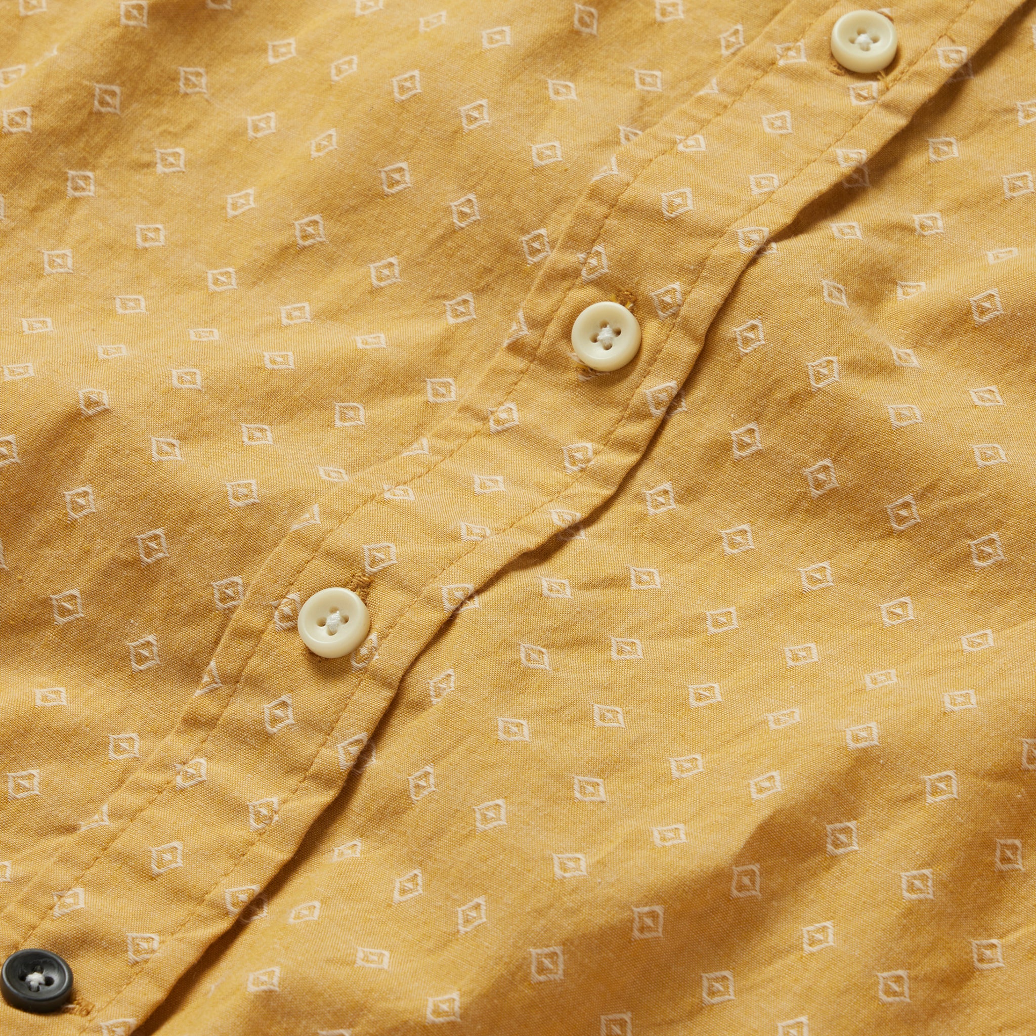 material shot of the buttons on The Short Sleeve Jack in Gold Diamond, Wovens by Taylor Stitch