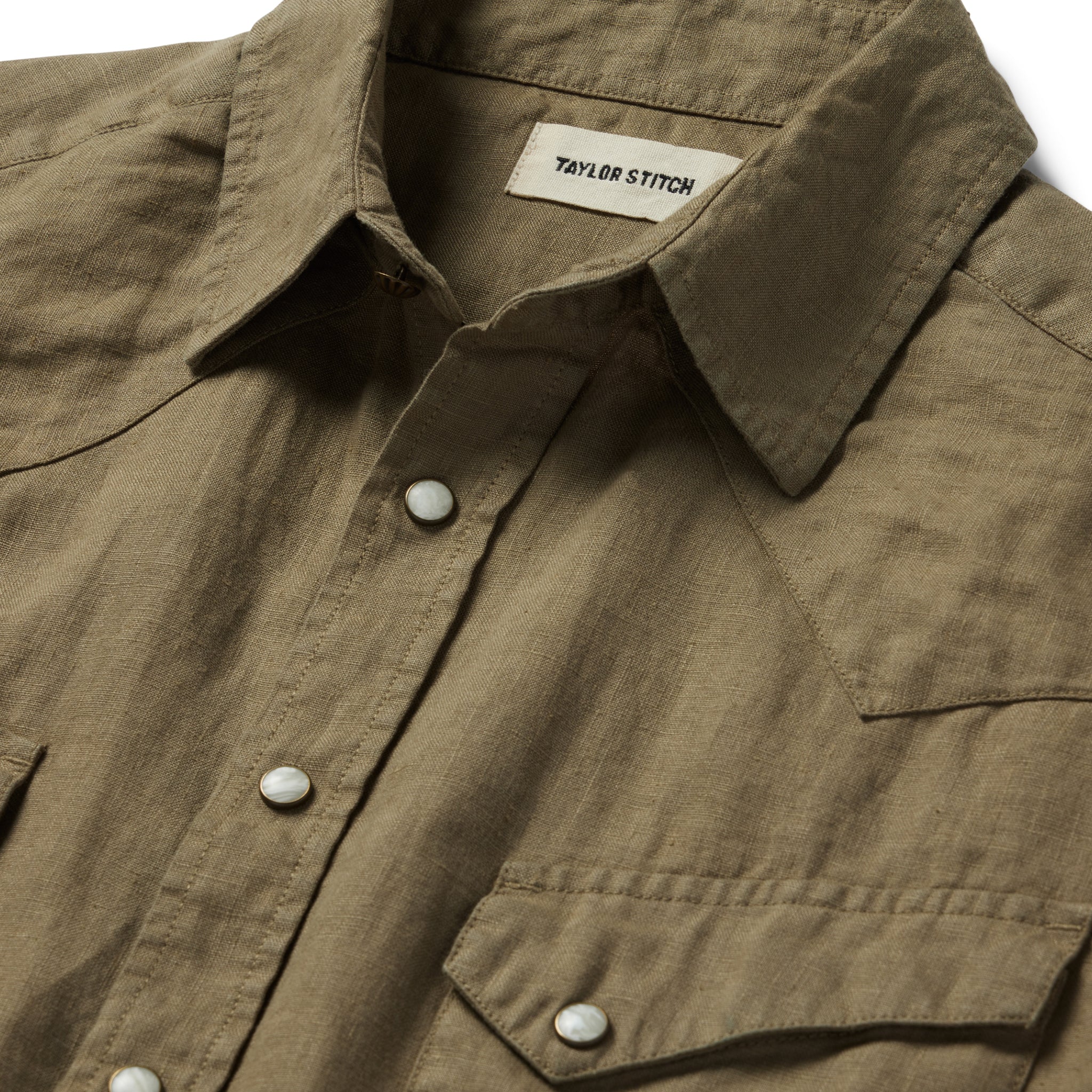 material shot of the collar and front yoke on The Short Sleeve Western in Olive Linen, Wovens by Taylor Stitch