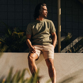 fit model sitting in The Short Sleeve Fillmore Crew in Olive