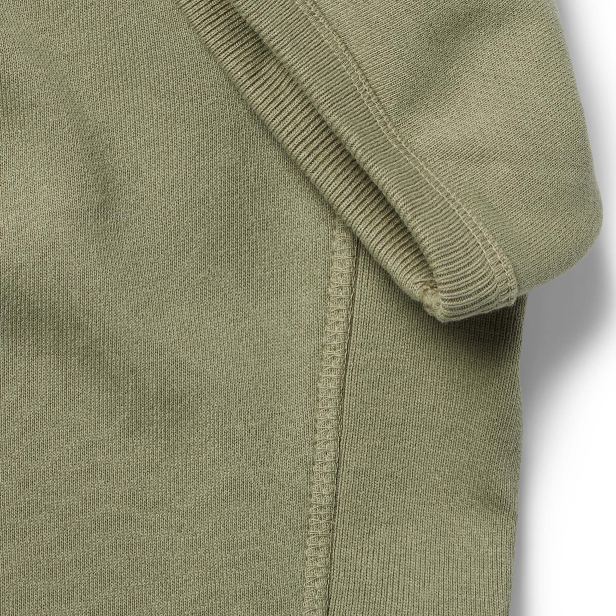 material shot of the ribbed sleeves on The Short Sleeve Fillmore Crew in Olive, Knits by Taylor Stitch
