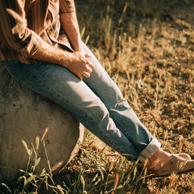 fit model sitting in The Slim Jean in Patch Wash Selvage