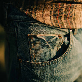 fit model showing the pocket detail of The Slim Jean in Patch Wash Selvage