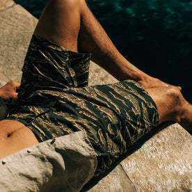 fit model sitting in The Adventure Short in Tiger Camo