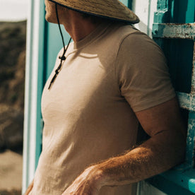 fit model leaning against the wall wearing The Cotton Hemp Tee in Khaki