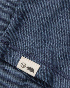 material shot of the hem and logo on The Cotton Hemp Tee in Slate and Navy Stripe, Knits by Taylor Stitch