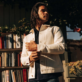 fit model adjusting the cuffs on The Dispatch Jacket in Natural