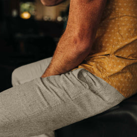 fit model sitting in The Easy Pant in Olive Herringbone