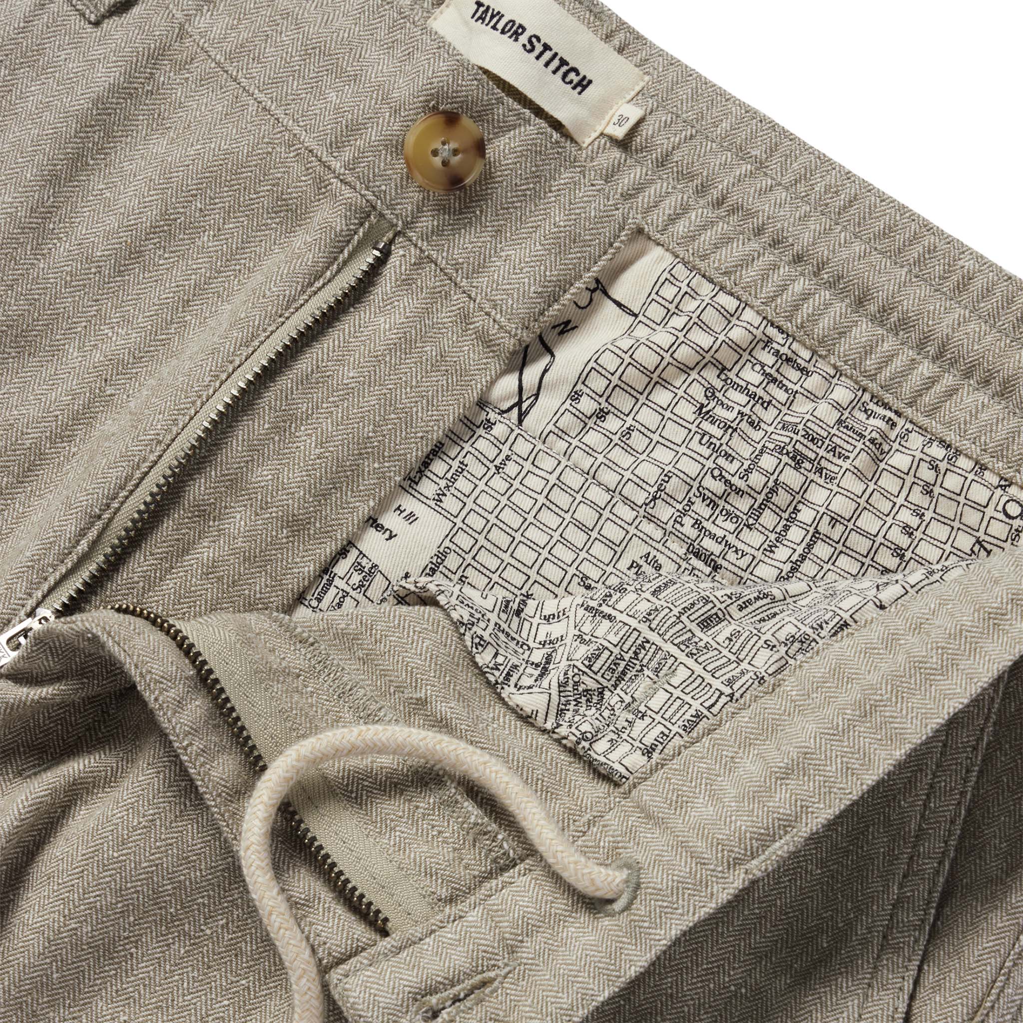 material shot of the internal drawstring and SF map print on The Easy Pant in Olive Herringbone, Bottoms by Taylor Stitch