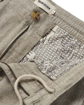 material shot of the internal drawstring and SF map print on The Easy Pant in Olive Herringbone, Bottoms by Taylor Stitch