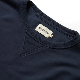 material shot of the ribbed collar and label on The Fillmore Crewneck in Dark Navy