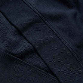 material shot of the ribbed hem on The Fillmore Crewneck in Dark Navy