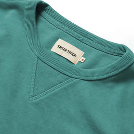 material shot of the ribbed collar and label on The Fillmore Crewneck in Teal