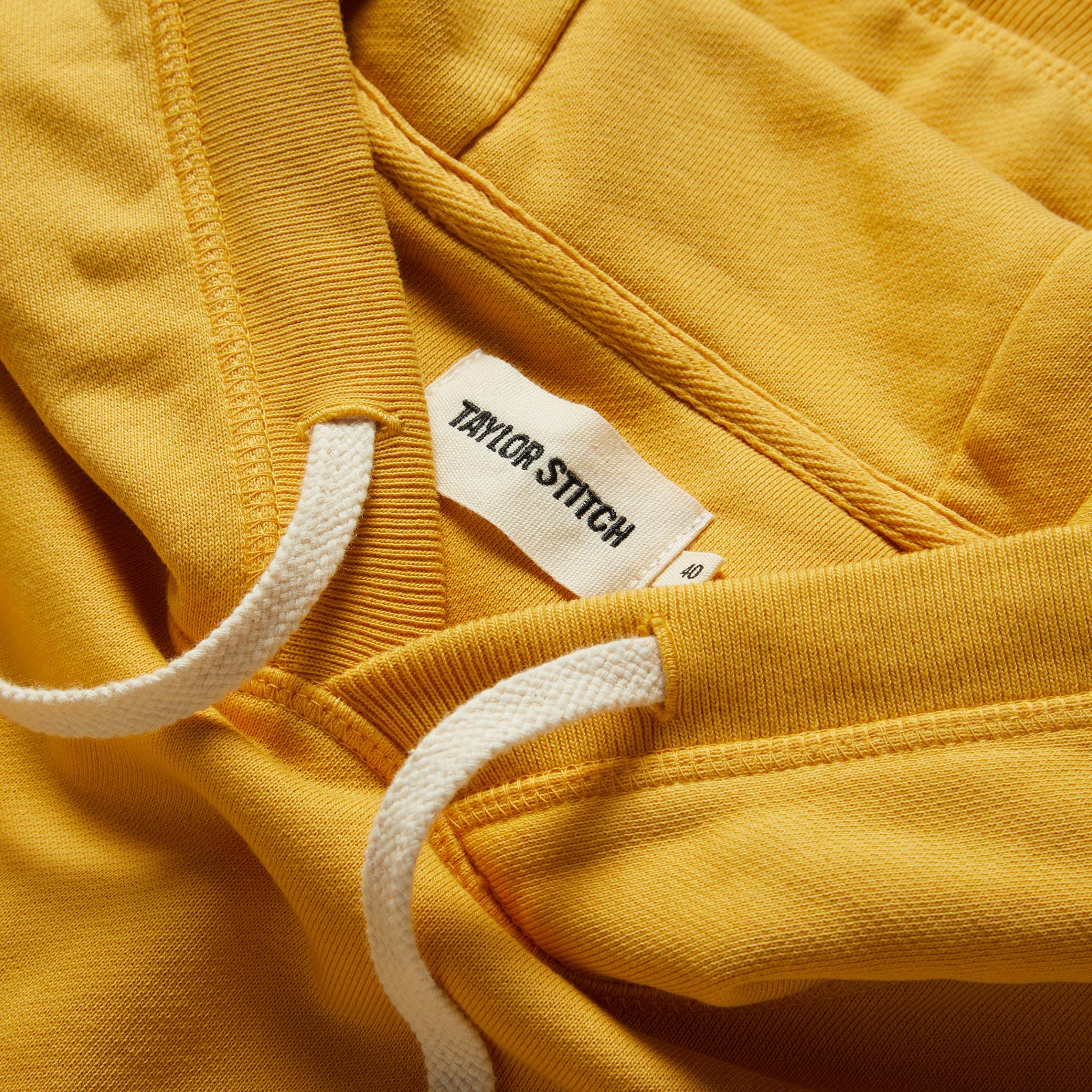 material shot of the drawstrings and hood on The Fillmore Hoodie in Canary, Knits by Taylor Stitch