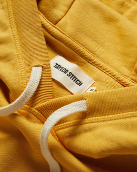 material shot of the drawstrings and hood on The Fillmore Hoodie in Canary, Knits by Taylor Stitch