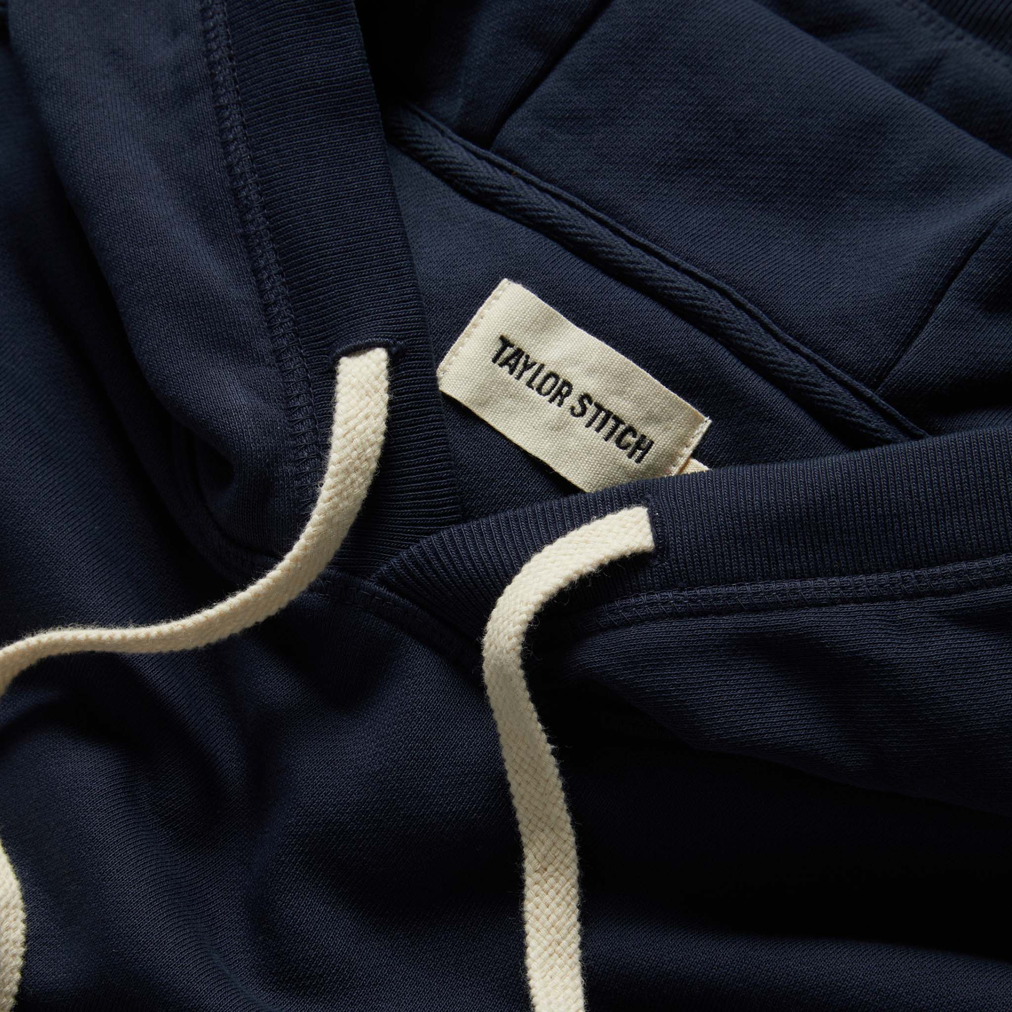 material shot of the drawstrings on The Fillmore Hoodie in Dark Navy, Knits by Taylor Stitch