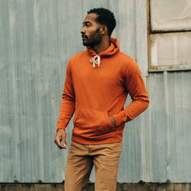 fit model walking in The Fillmore Hoodie in Rust