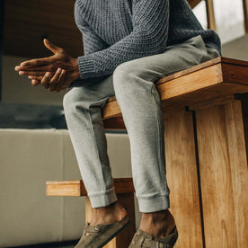 fit model sitting on a table in The Fillmore Pant in Heather Grey