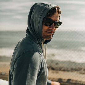 fit model wearing The Fillmore Hoodie in Ocean and Natural  with the hood up