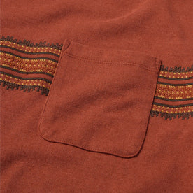 material shot of the chest pocket on The Heavy Bag Tee in Dusty Rose Embroidered Stripe