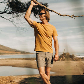 fit model holding a tree branch in The Heavy Bag Tee in Gold