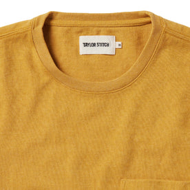 material shot of the front of The Heavy Bag Tee in Gold