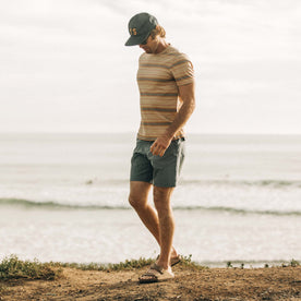 fit model walking on the beach in The Organic Cotton Tee in Sand Stripe