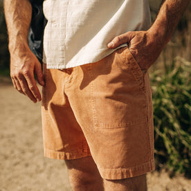 fit model standing with his hand in the pocket of The Trail Short in Apricot Micro Cord