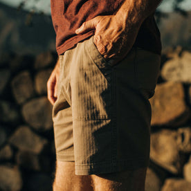 fit model posing with his hand in the pocket of The Trail Short in Khaki Herringbone