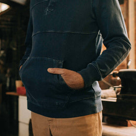 fit model wearing The Turnover Shirt in Washed Indigo with his hands in the kangaroo pocket