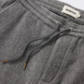 material shot of the drawcords and elasticated waist on The Apres Short in Charcoal Waffle