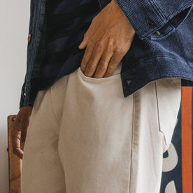 fit model showing the pocket on The Democratic All Day Pant in Dune Canvas