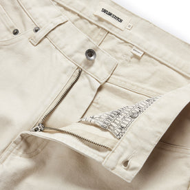 material shot of the button fly undone on The Democratic All Day Pant in Dune Canvas