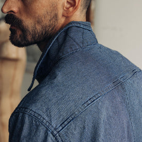 fit model showing the back of The Long Haul Jacket in Washed Indigo Stripe
