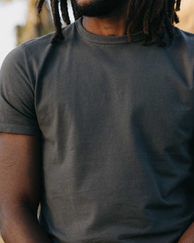 fit model posing in The Organic Cotton Tee in Faded Black, Knits by Taylor Stitch