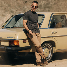 fit model posing by a vintage mercedes in The Organic Cotton Tee in Faded Black