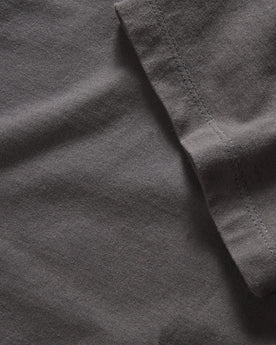 material shot of the sleeve on The Organic Cotton Tee in Faded Black, Knits by Taylor Stitch