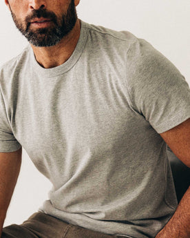 fit model sitting wearing The Organic Cotton Tee in Heather Grey, Knits by Taylor Stitch