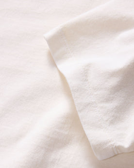 material shot of the sleeve on The Organic Cotton Tee in Vintage White, Knits by Taylor Stitch
