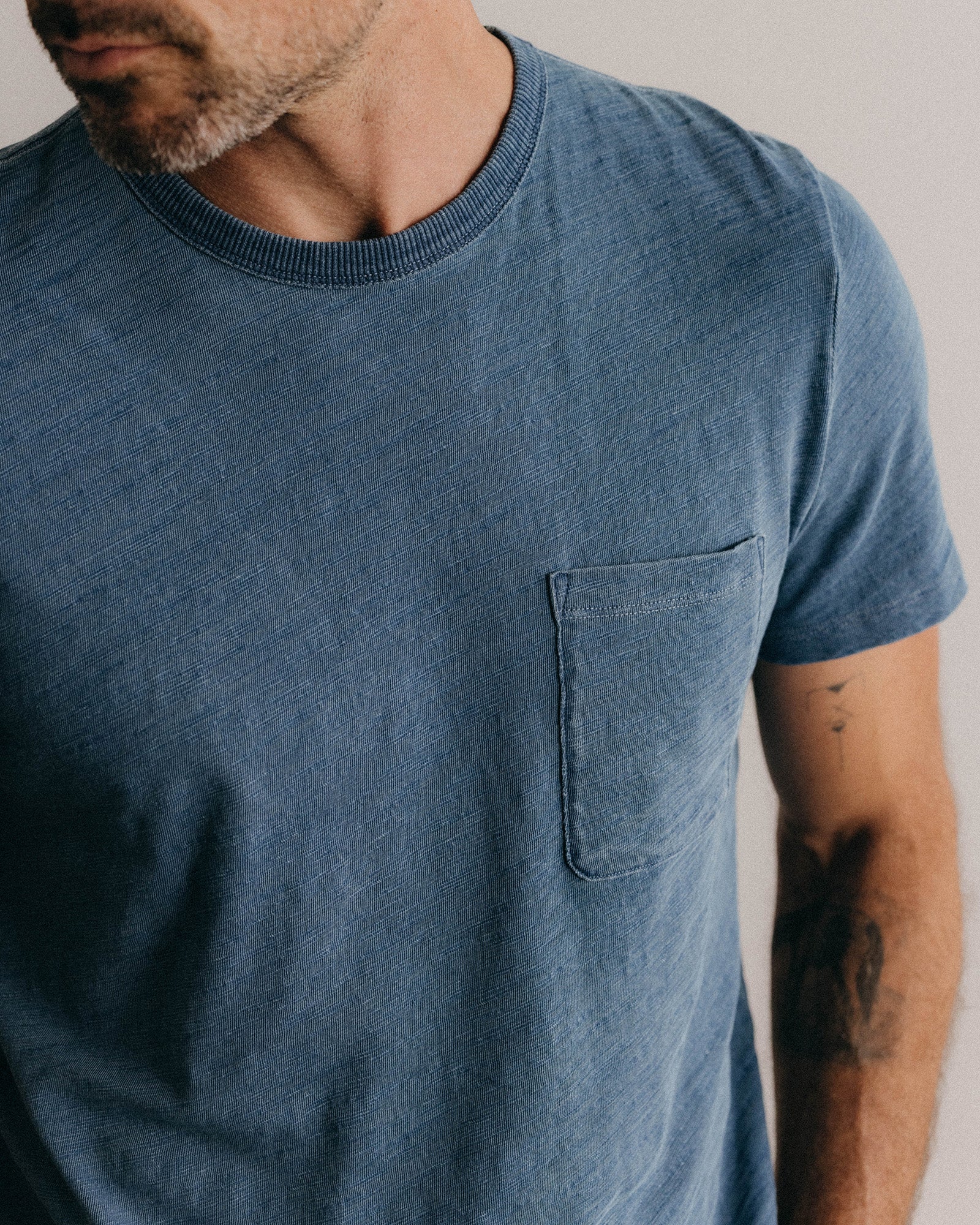 fit model showing the textural detail on The Organic Cotton Tee in Dyed Indigo, Knits by Taylor Stitch