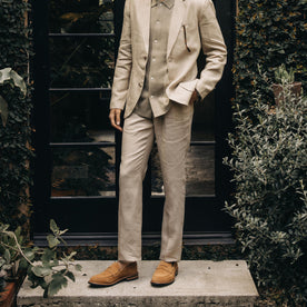 fit model standing by a doorway in The Sheffield Trouser in Natural Linen