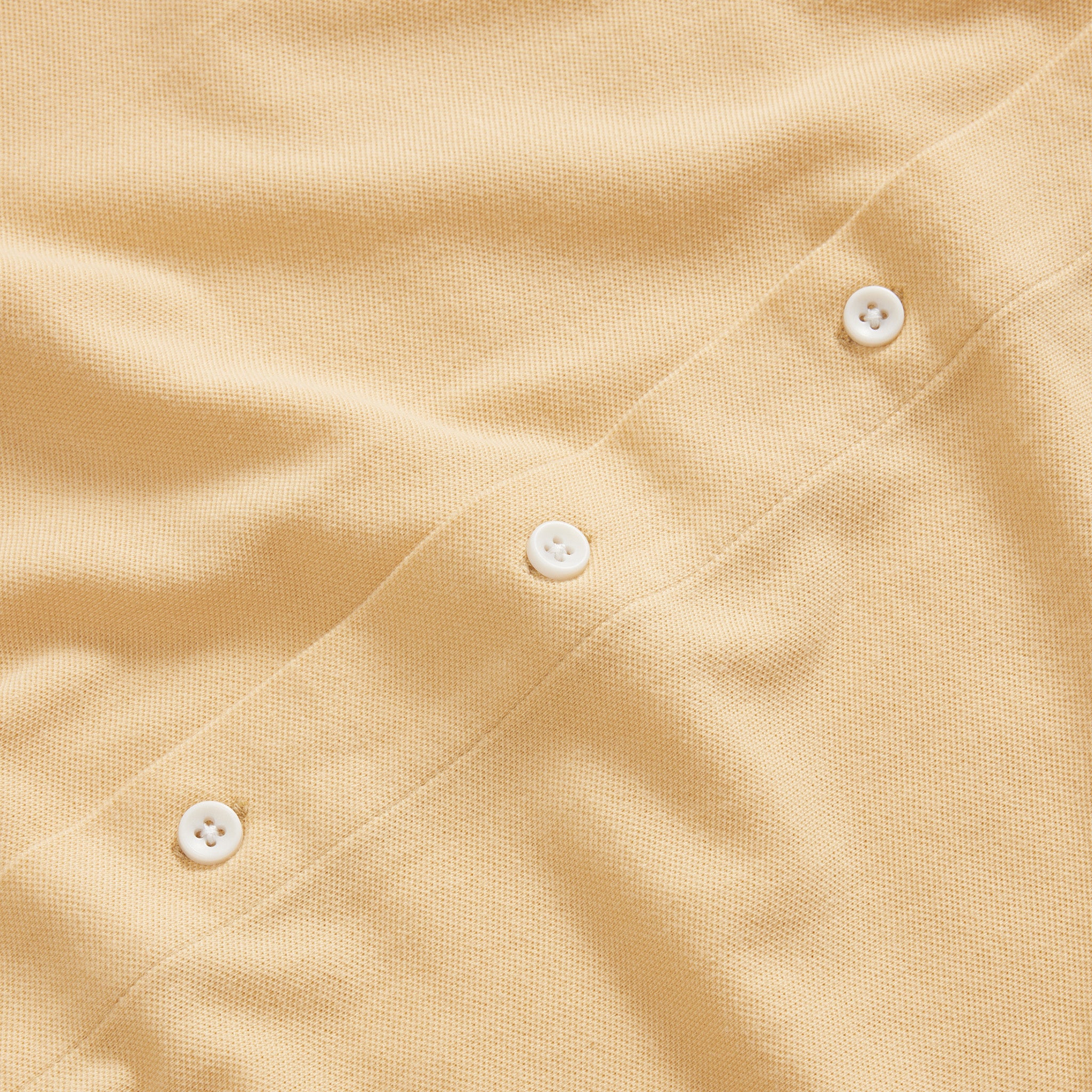 material shot of the natural buttons on The Short Sleeve California in Oak Pique, Knits by Taylor Stitch
