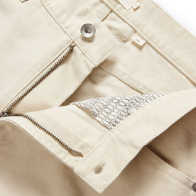 material shot of the button fly undone on The Slim All Day Pant in Dune Canvas