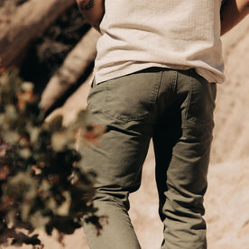 fit model showing the back of The Slim All Day Pant in Arid Eucalyptus Canvas