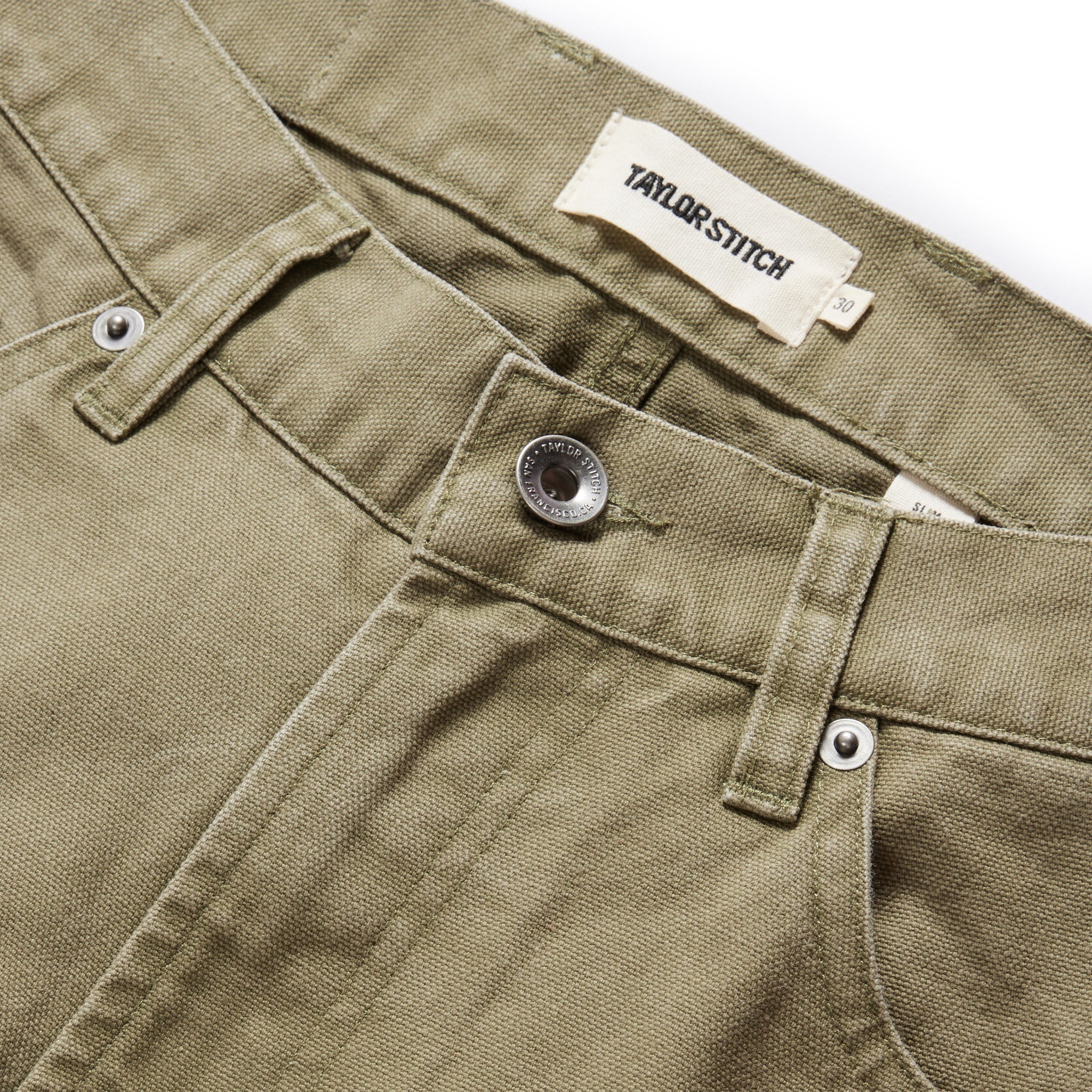 material shot of the button fly on The Slim All Day Pant in Arid Eucalyptus Canvas, Bottoms by Taylor Stitch