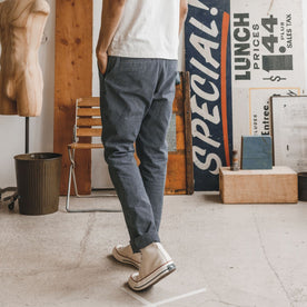 fit model facing the back in The Morse Pant in Washed Indigo Stripe
