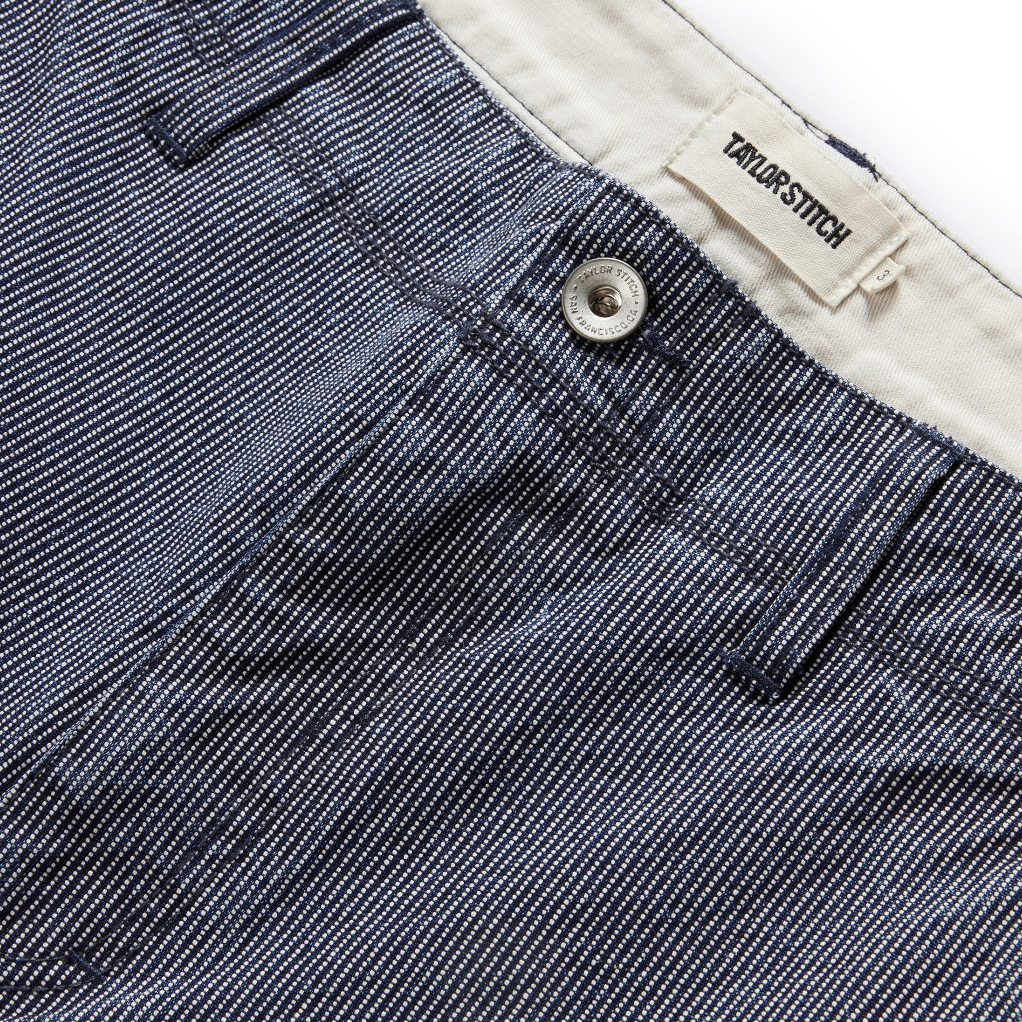 material shot of the button fly on The Morse Pant in Washed Indigo Stripe, Bottoms by Taylor Stitch