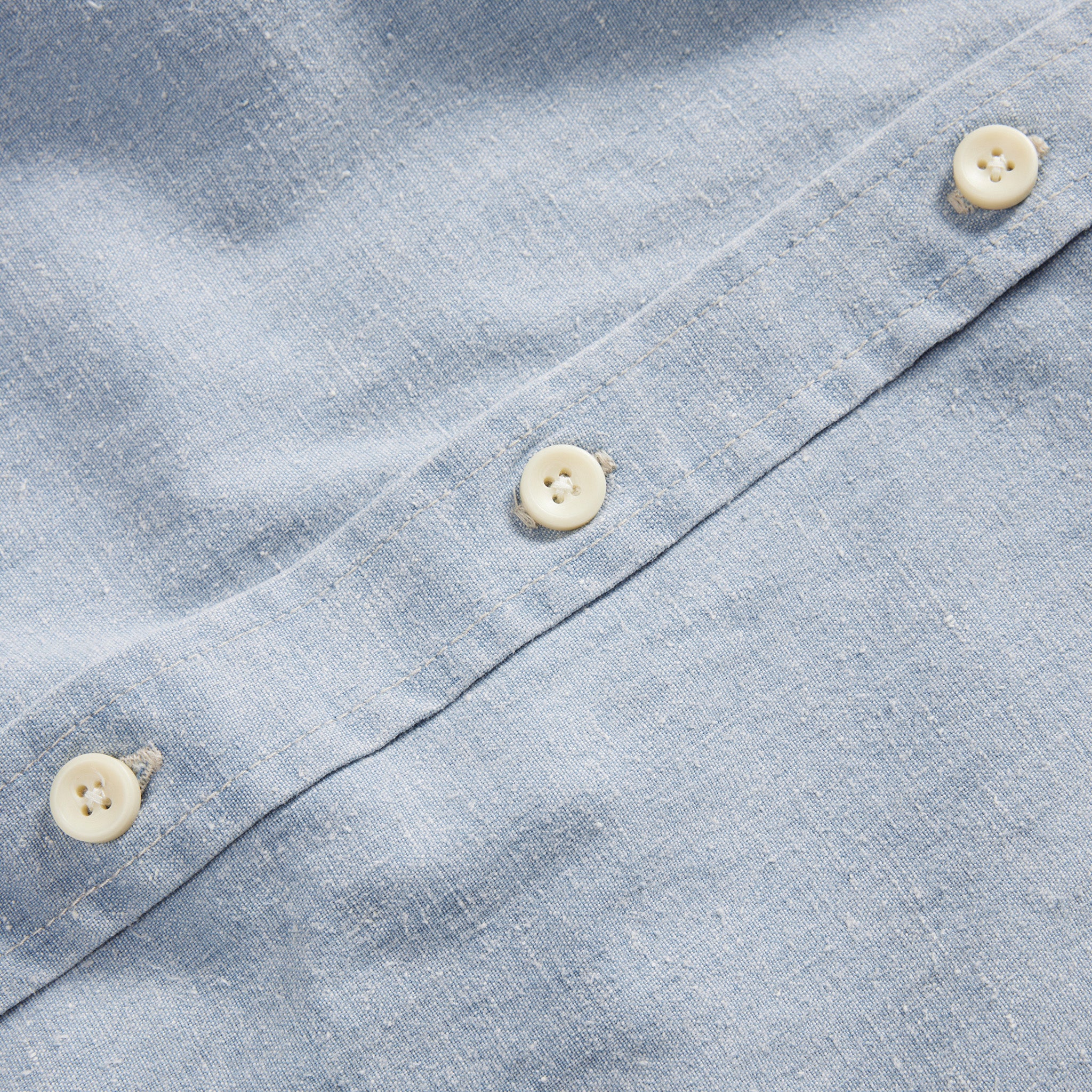 material shot of the buttons on The Utility Shirt in Washed Indigo Boss Duck, Wovens by Taylor Stitch