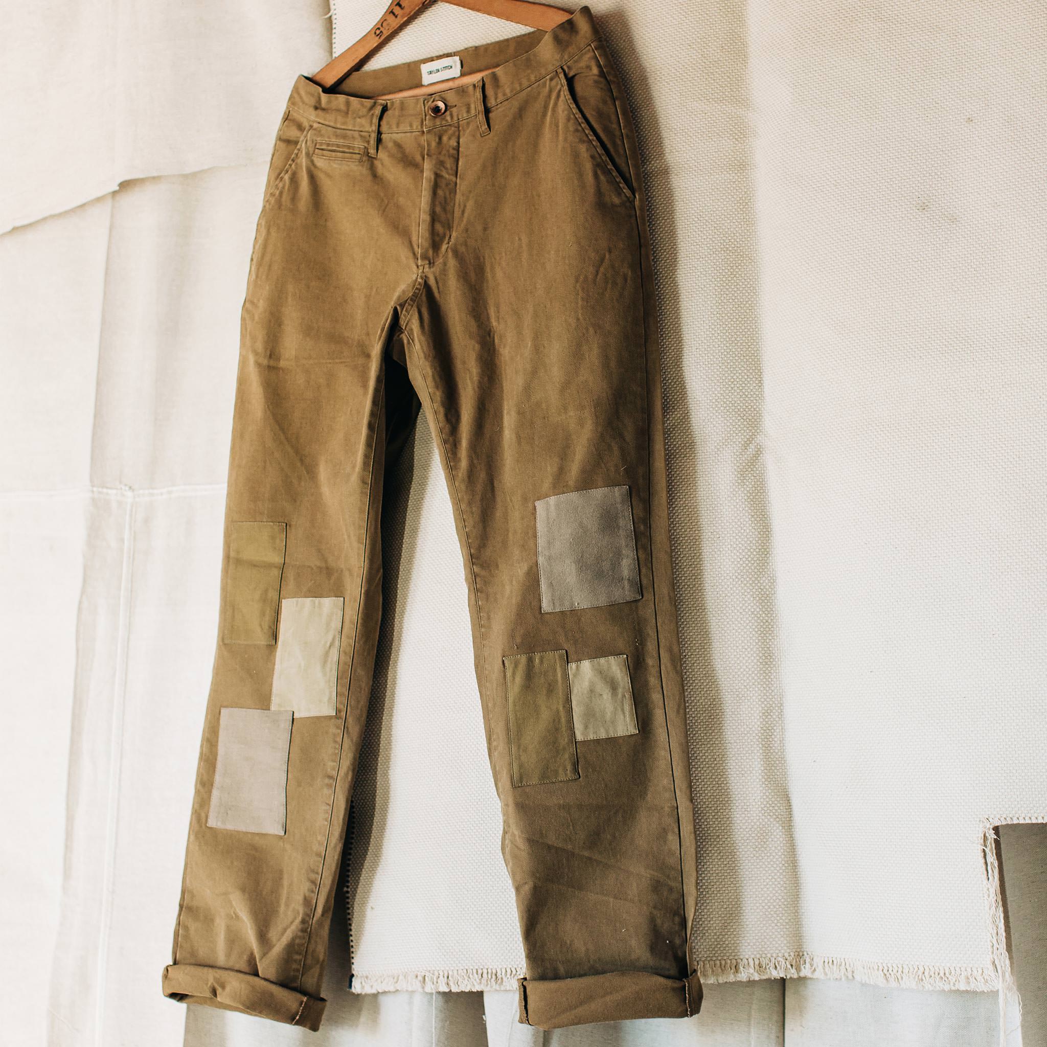 material shot of The Atelier and Repairs Chino in British Khaki, hanging in studio, Bottoms by Taylor Stitch