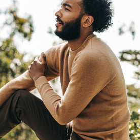 fit model wearing The Double Knit Sweater in British Khaki, sitting